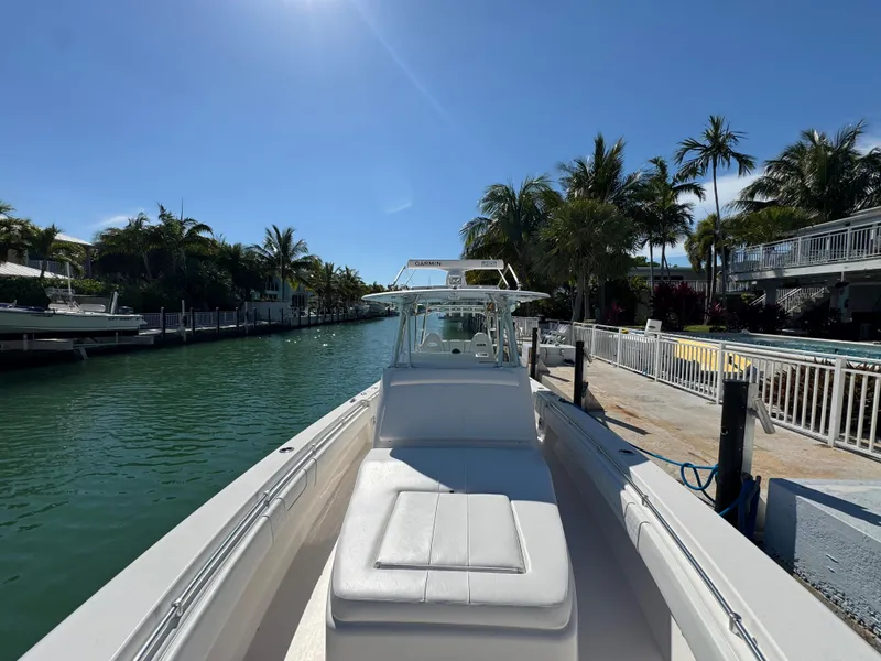 Slide: The Image of 2021 Contender 39 Fisharound boat docked by a tropical canal. - 18