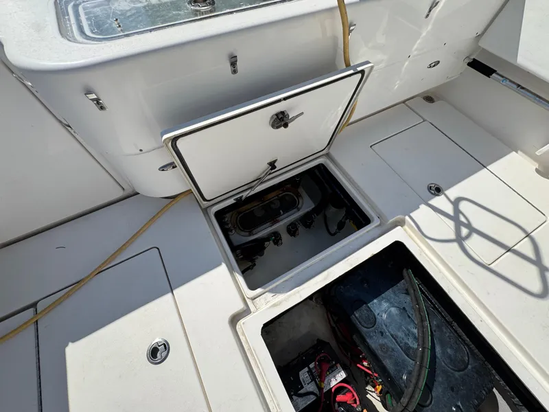 Slide: The Image of Contender 39 Fisharound 2021 boat deck with open storage compartments and visible equipment. - 21