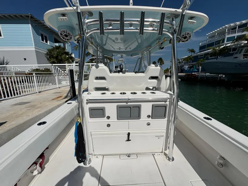 Slide: The Image of 2021 Contender 39 Fisharound boat with center console and rod holders, docked by waterfront homes. - 23