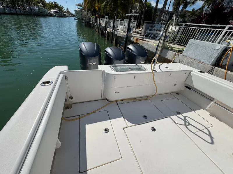Slide: The Image of 2021 Contender 39 Fisharound boat docked with dual outboard engines. - 26