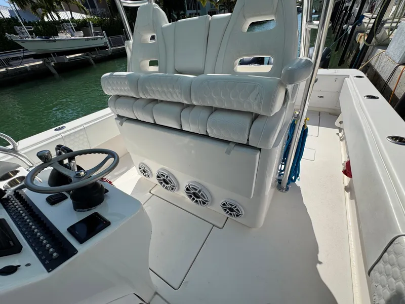 Slide: The Image of 2021 Contender 39 Fisharound boat interior with white seating and steering console. - 28