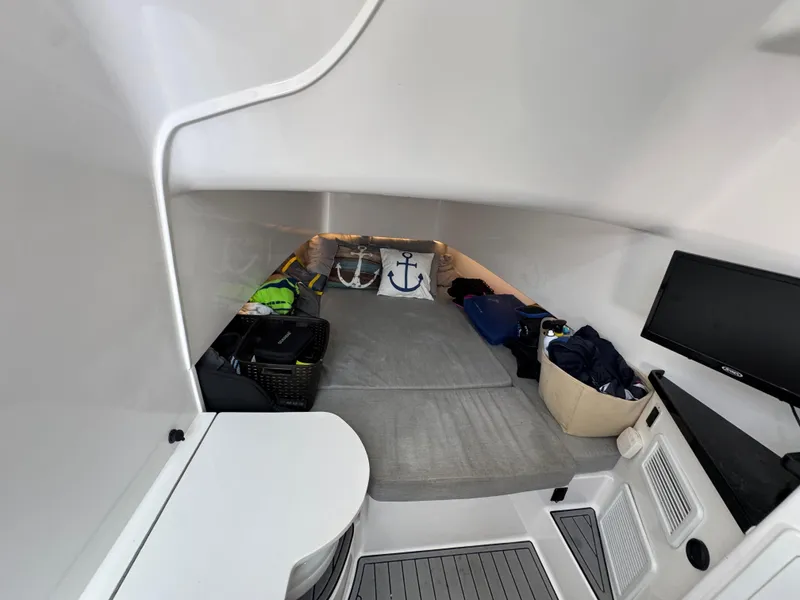 Slide: The Image of 2021 Contender 39 Fisharound cabin interior with TV, storage, and anchor-themed decor. - 29