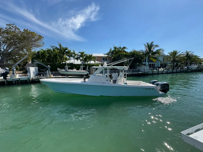 Slide: The Image of 2021 Contender 39 Fisharound boat cruising on a sunny, tropical waterway. - 3