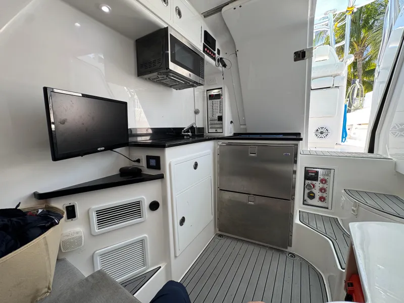 Slide: The Image of 2021 Contender 39 Fisharound interior with modern kitchen appliances and sleek design. - 31