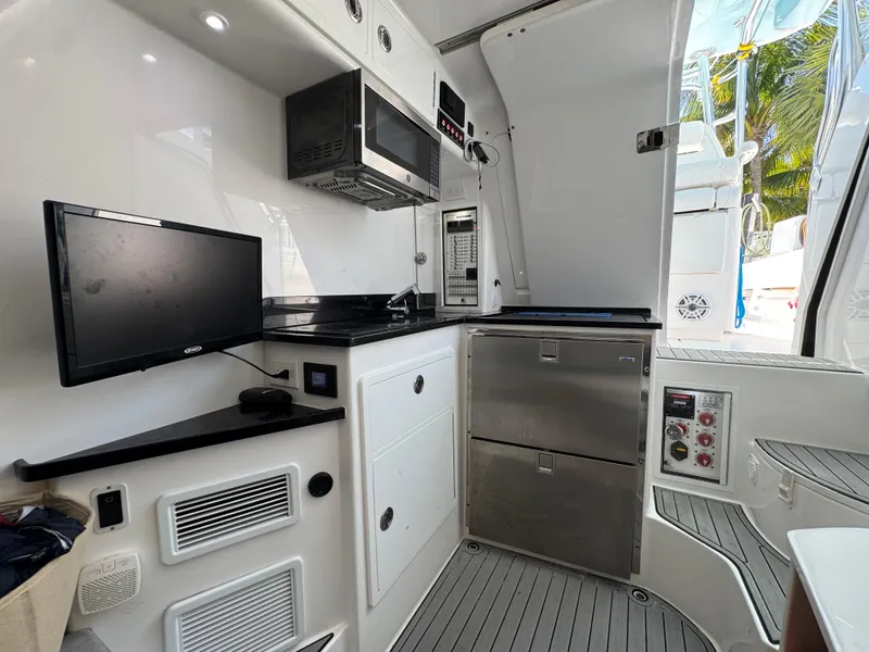 Slide: The Image of 2021 Contender 39 Fisharound interior with modern kitchen appliances and sleek design. - 32
