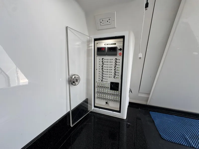 Slide: The Image of Electrical panel inside 2021 Contender 39 Fisharound boat, featuring circuit breakers and control switches. - 35