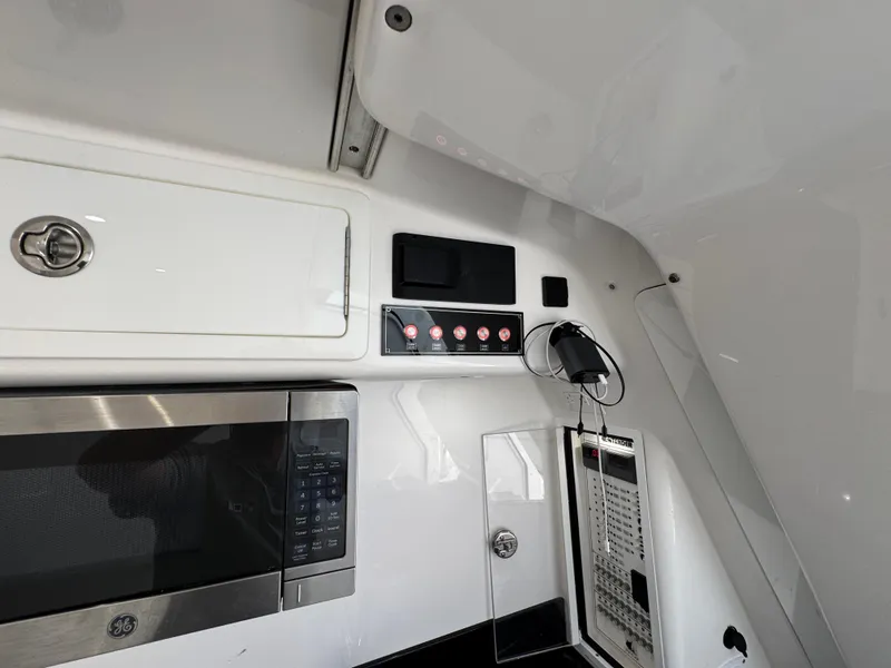 Slide: The Image of Interior view of 2021 Contender 39 Fisharound boat with microwave and control panel. - 36