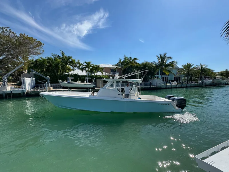 Slide: The Image of 2021 Contender 39 Fisharound boat cruising on a sunny, tropical waterway. - 4