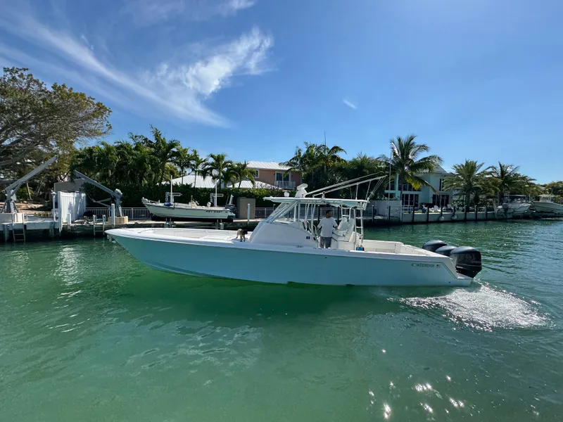 Slide: The Image of 2021 Contender 39 Fisharound boat cruising on a sunny day in a tropical canal. - 5