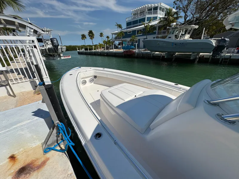 Slide: The Image of 2021 Contender 39 Fisharound boat docked in a sunny marina setting. - 6