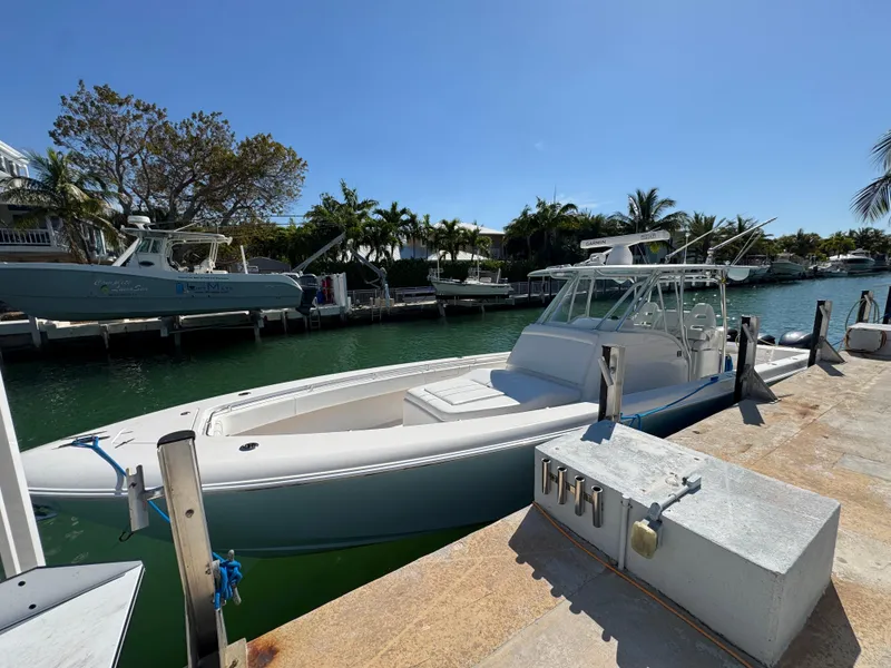 Slide: The Image of 2021 Contender 39 Fisharound boat docked in a sunny marina setting. - 7