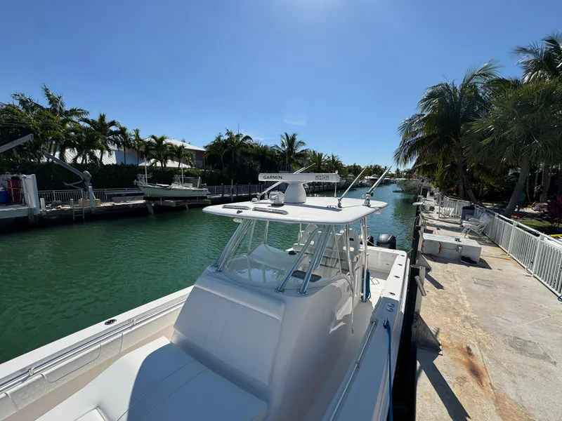 Slide: The Image of 2021 Contender 39 Fisharound boat docked by a tropical canal. - 8