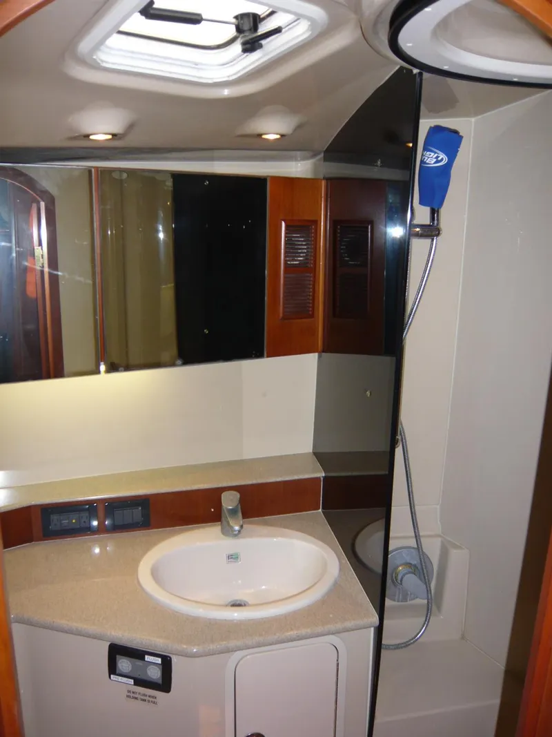 Slide: The Image of 2004 Rampage 38 Express yacht bathroom with sink, mirror, and shower. - 13