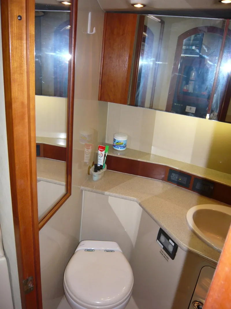 Slide: The Image of 2004 Rampage 38 Express yacht bathroom with mirror, sink, and toilet. - 14