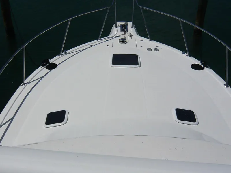 Slide: The Image of Bow view of 2004 Rampage 38 Express boat with hatches and railings. - 16