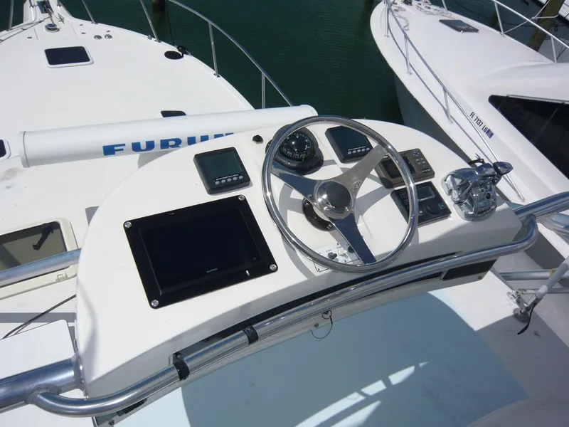 Slide: The Image of 2004 Rampage 38 Express boat helm with steering wheel and navigation equipment. - 17