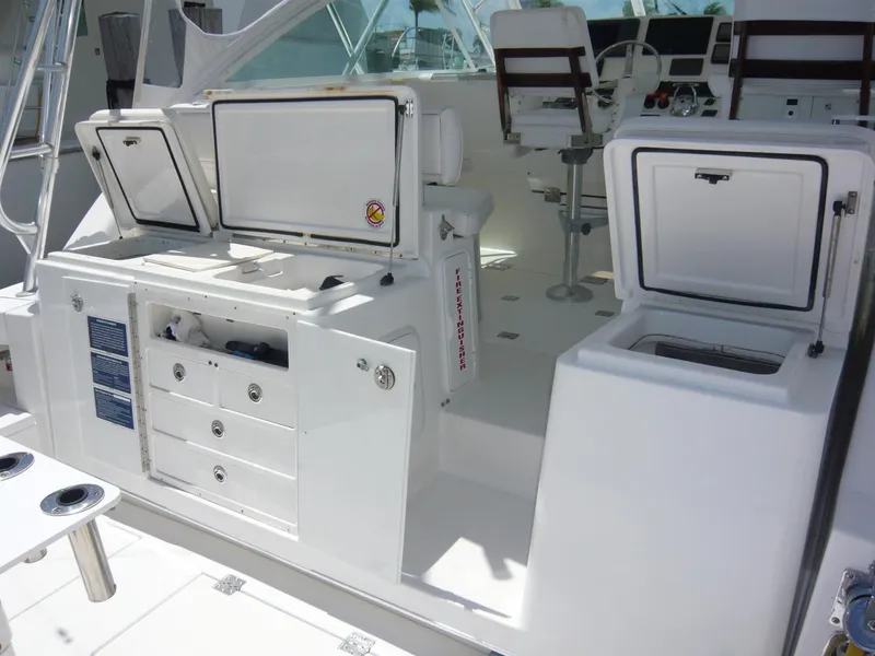 Slide: The Image of 2004 Rampage 38 Express boat interior with open storage compartments and seating. - 20