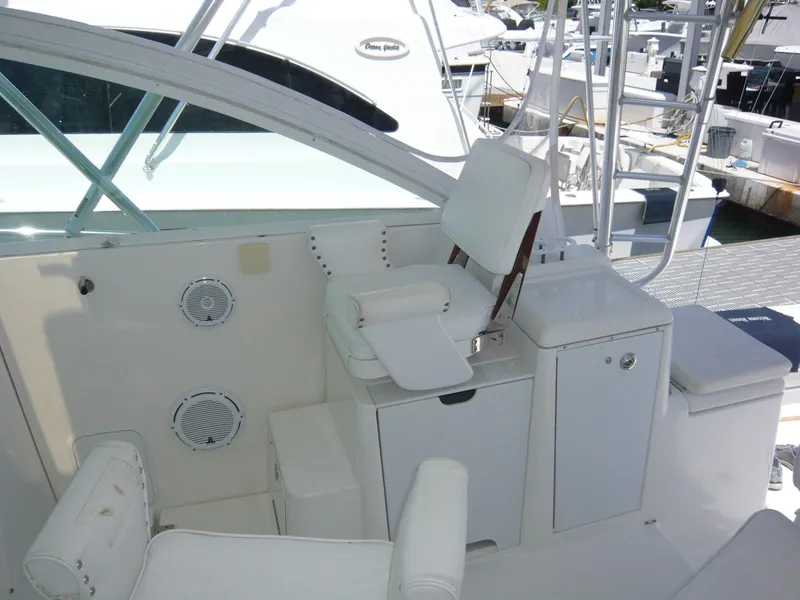 Slide: The Image of 2004 Rampage 38 Express boat interior with white seating and storage compartments. - 24