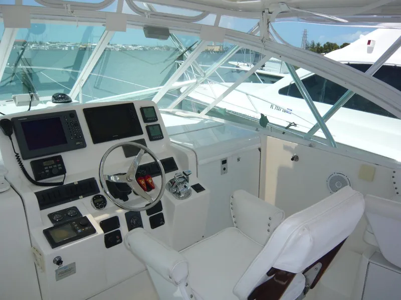 Slide: The Image of 2004 Rampage 38 Express helm with navigation equipment and white seating. - 25