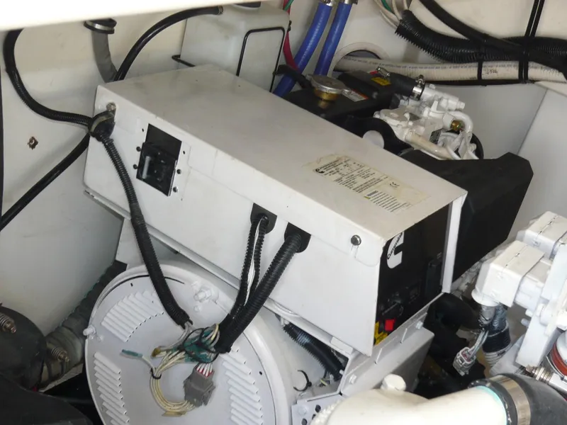 Slide: The Image of Engine room of 2004 Rampage 38 Express boat, featuring mechanical components and wiring. - 28