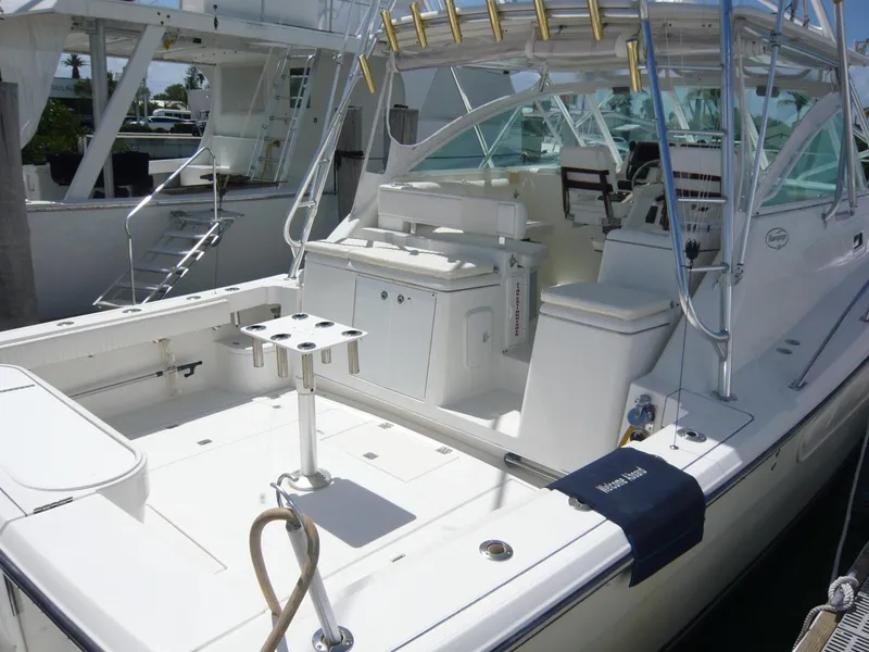 Slide: The Image of 2004 Rampage 38 Express boat with spacious deck and fishing setup. - 6