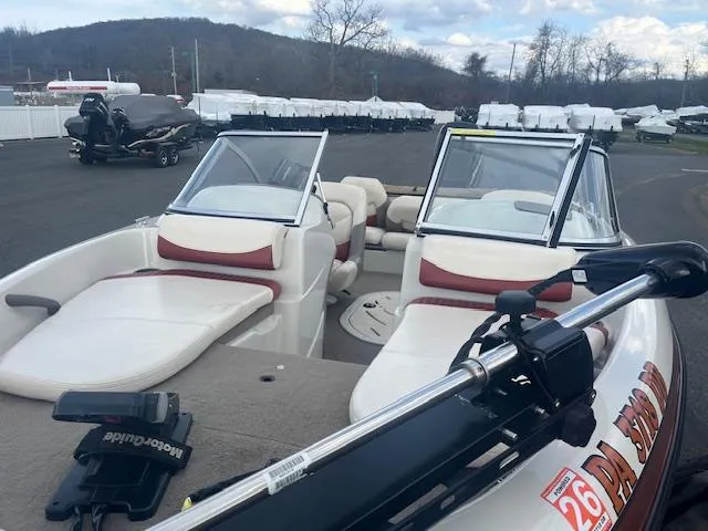 Slide: The Image of 2009 Nitro 189 Sport boat with seating, parked outdoors on a cloudy day. - 13