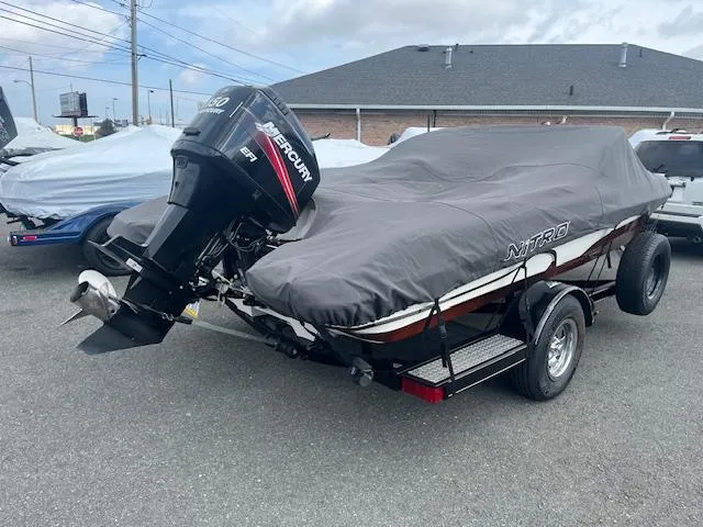 Slide: The Image of 2009 Nitro 189 Sport boat with cover and Mercury outboard motor in parking lot. - 15