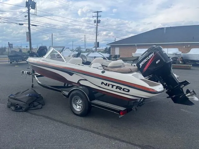 Slide: The Image of 2009 Nitro 189 Sport boat with Mercury engine on trailer in parking lot. - 2