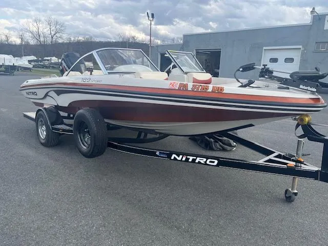 Slide: The Image of 2009 Nitro 189 Sport boat on trailer, parked outdoors near a building. - 3