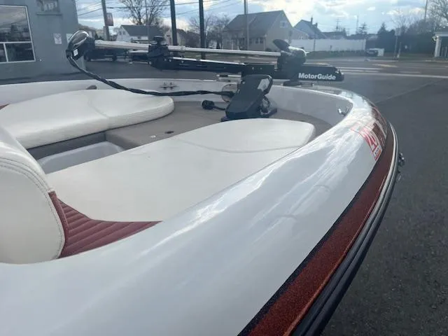 Slide: The Image of 2009 Nitro 189 Sport boat with MotorGuide trolling motor, parked outdoors. - 4