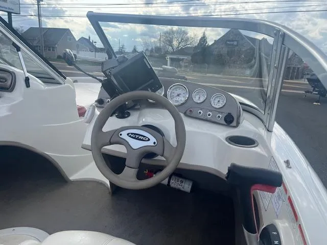 Slide: The Image of 2009 Nitro 189 Sport boat dashboard with steering wheel and gauges. - 5