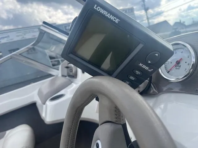 Slide: The Image of Lowrance X86 fishfinder on 2009 Nitro 189 Sport boat dashboard, steering wheel visible. - 6