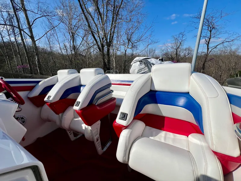 Slide: The Image of 1999 Black Thunder 430 Flat Deck boat interior with red, white, and blue seating. - 17
