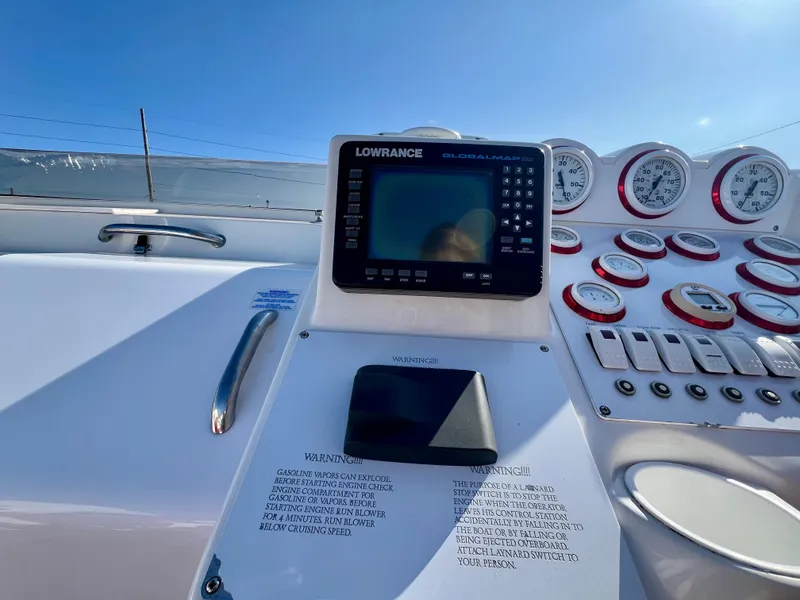 Slide: The Image of Control panel of a 1999 Black Thunder 430 Flat Deck boat with Lowrance display and gauges. - 21