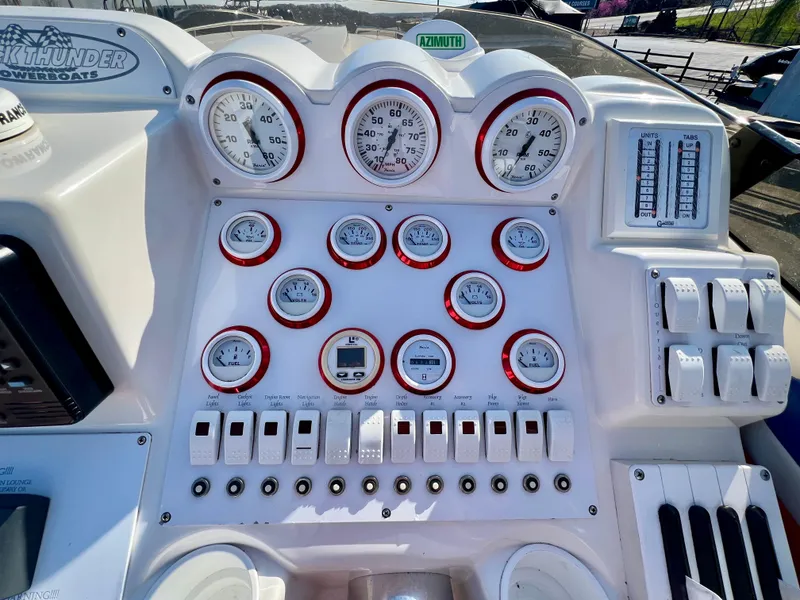 Slide: The Image of Control panel of a 1999 Black Thunder 430 Flat Deck boat with gauges and switches. - 22