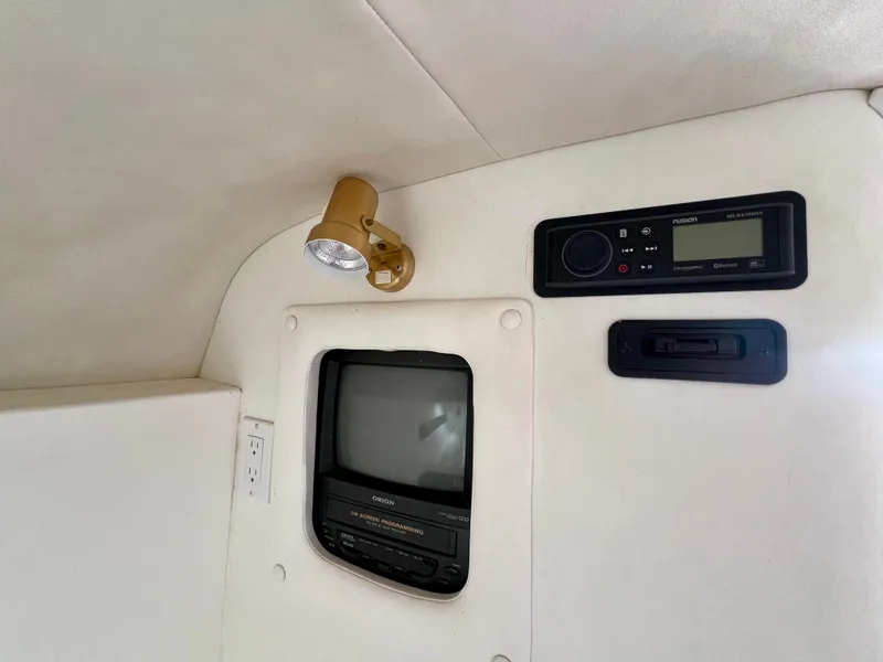 Slide: The Image of Interior of 1999 Black Thunder 430 Flat Deck with vintage TV and audio system. - 26