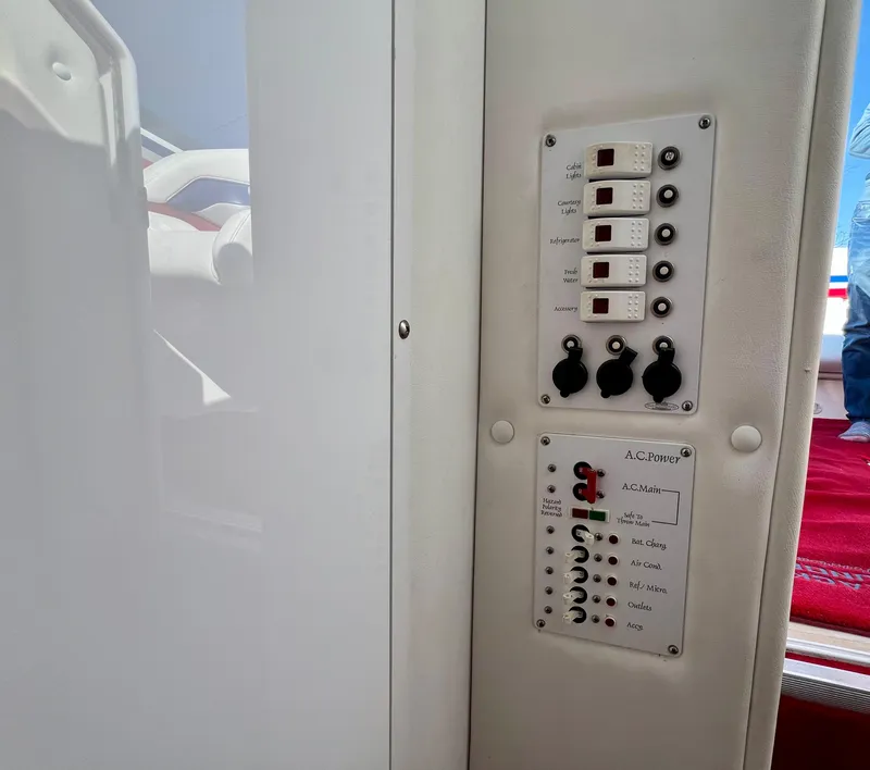 Slide: The Image of Control panel inside 1999 Black Thunder 430 Flat Deck boat, featuring switches and indicators. - 27