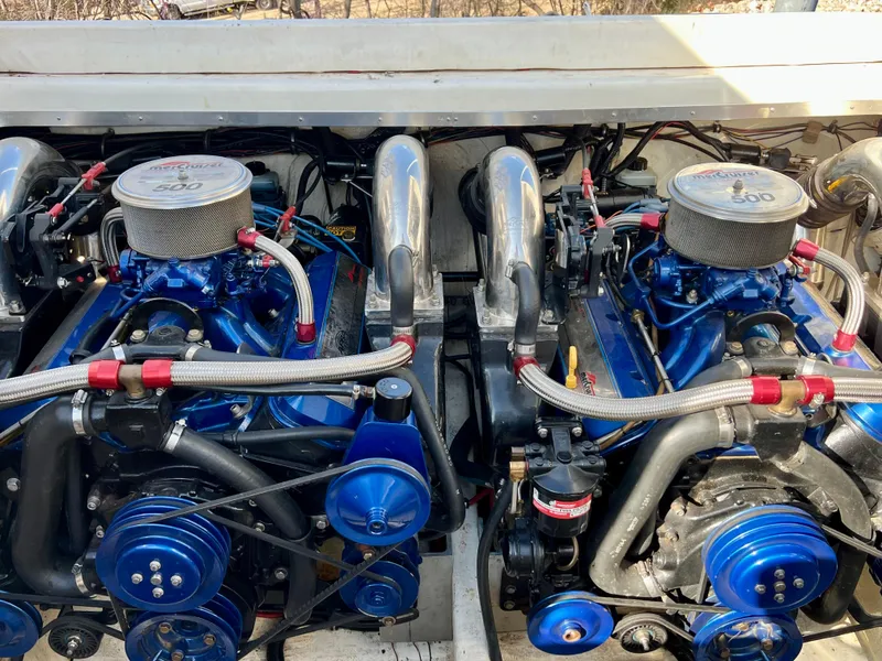 Slide: The Image of Twin engines of a 1999 Black Thunder 430 Flat Deck boat, showcasing detailed components. - 34