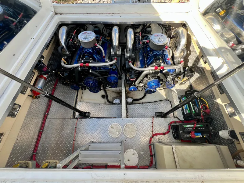 Slide: The Image of Engine compartment of a 1999 Black Thunder 430 Flat Deck boat, featuring dual engines. - 35