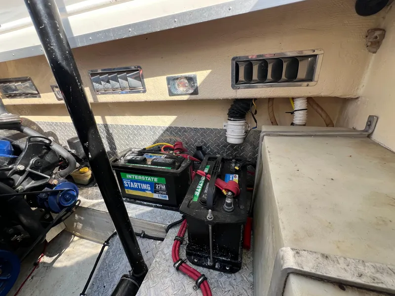 Slide: The Image of 1999 Black Thunder 430 Flat Deck boat interior with batteries and engine components. - 36