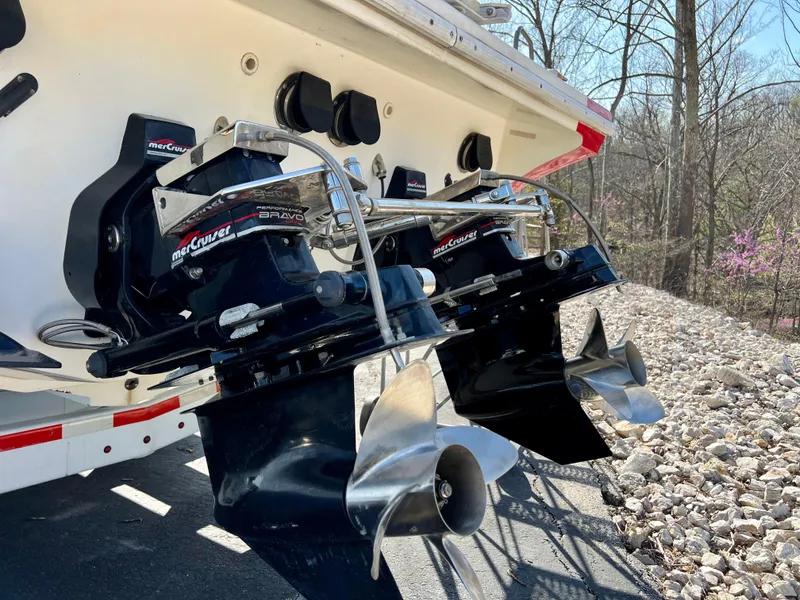 Slide: The Image of Twin propellers on a 1999 Black Thunder 430 Flat Deck boat, parked outdoors. - 38