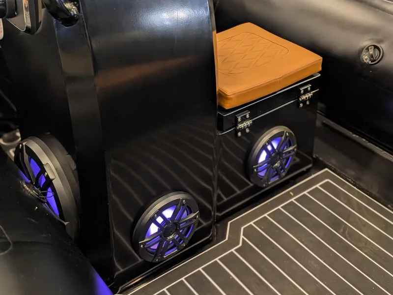 Slide: The Image of 2025 Tide Craft Custom Catalina 13 interior with speakers and cushioned seat. - 10