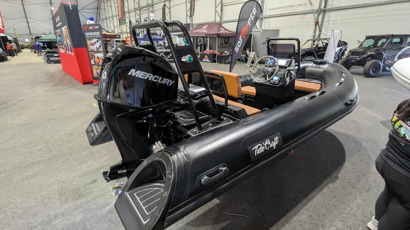 Slide: The Image of 2025 Tide Craft Custom Catalina 13 boat with Mercury engine on display indoors. - 2