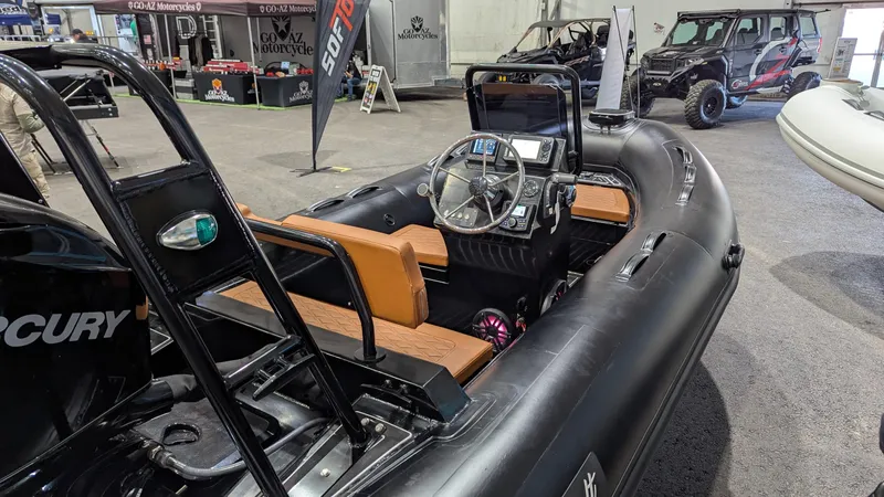 Slide: The Image of 2025 Tide Craft Custom Catalina 13 boat with sleek black design and modern dashboard. - 4