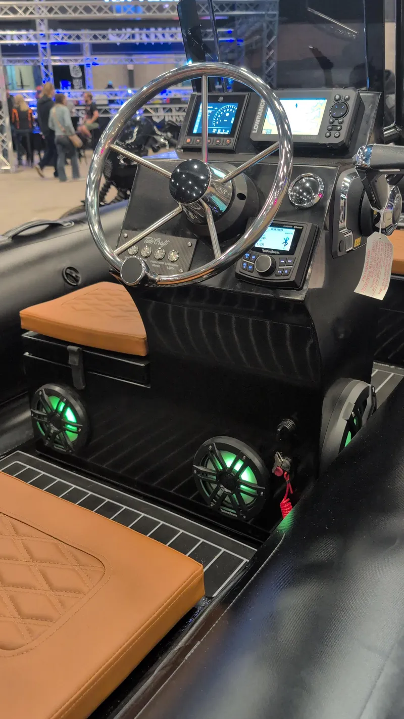 Slide: The Image of 2025 Tide Craft Custom Catalina 13 boat interior with modern dashboard and leather seating. - 7