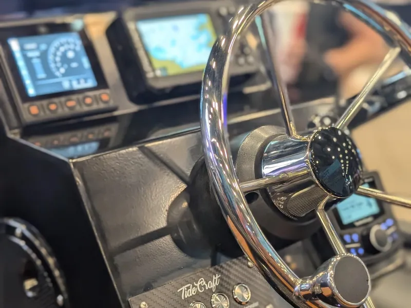 Slide: The Image of Steering wheel and dashboard of 2025 Tide Craft Custom Catalina 13 boat with navigation displays. - 8