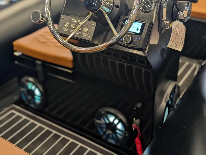 Slide: The Image of 2025 Tide Craft Custom Catalina 13 interior with steering wheel and modern controls. - 9
