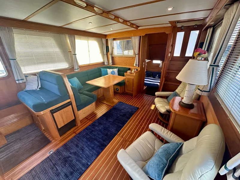 Slide: The Image of Interior of 1997 Sabre Cockpit Motor Yacht with elegant wood finish and cozy seating. - 11