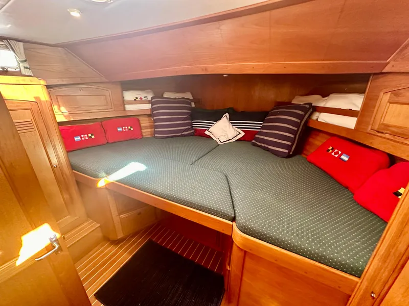 Slide: The Image of 1997 Sabre Cockpit Motor Yacht cabin with cozy bedding and wooden interior. - 26