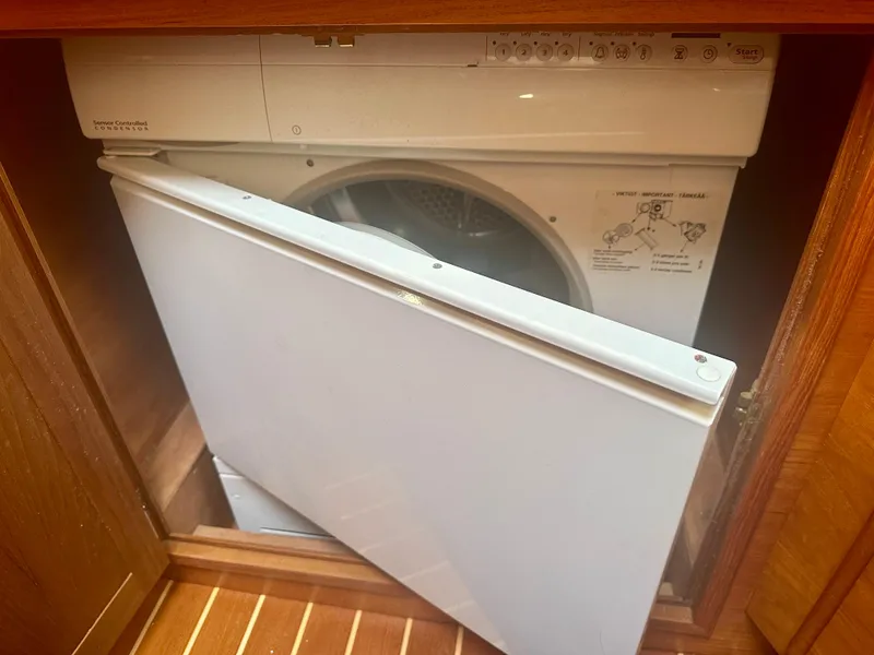 Slide: The Image of Washer-dryer unit in 1997 Sabre Cockpit Motor Yacht's wooden cabinet. - 30